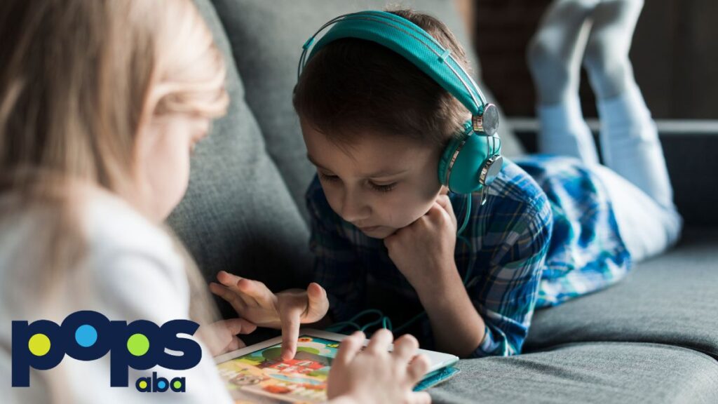 Two children, a boy and a girl, play together on a sofa with puzzle pieces, illustrating autism support and engagement.
