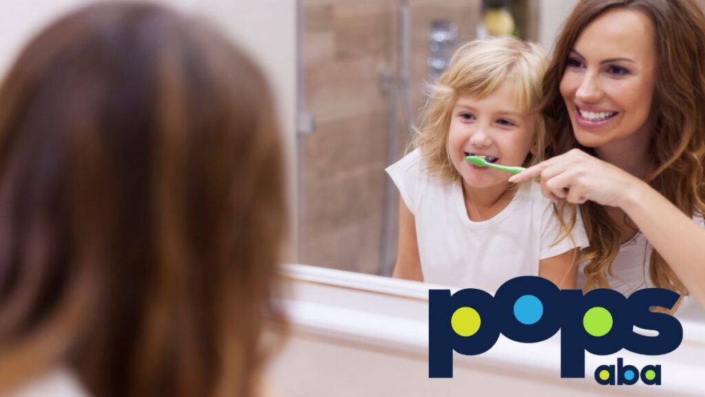 A parent guides their child brushing teeth, with their reflection visible in the mirror as part of the routine.